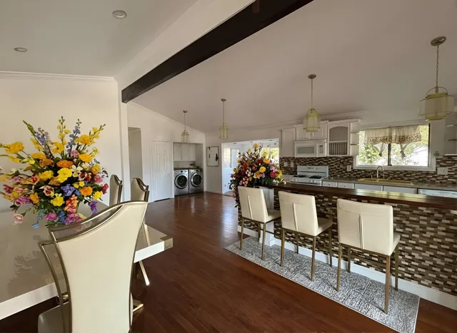 a view of a dining room with furniture and wooden floor