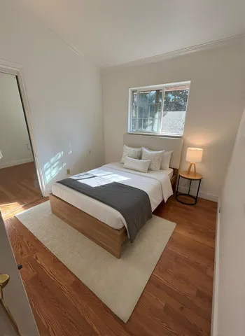 a bedroom with a bed and window