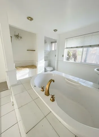 a bathroom with a tub and shower