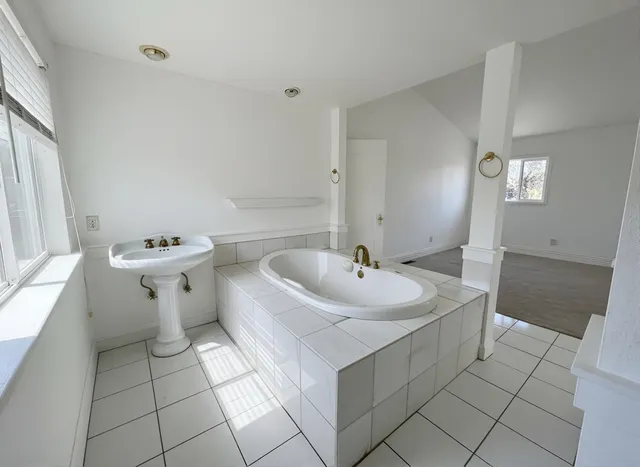 a bathroom with a sink a toilet and mirror