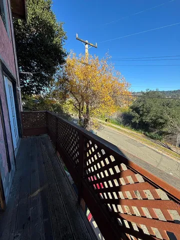a view of balcony with wooden floor and city view