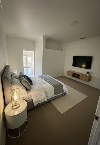 a bedroom with bed and a tv