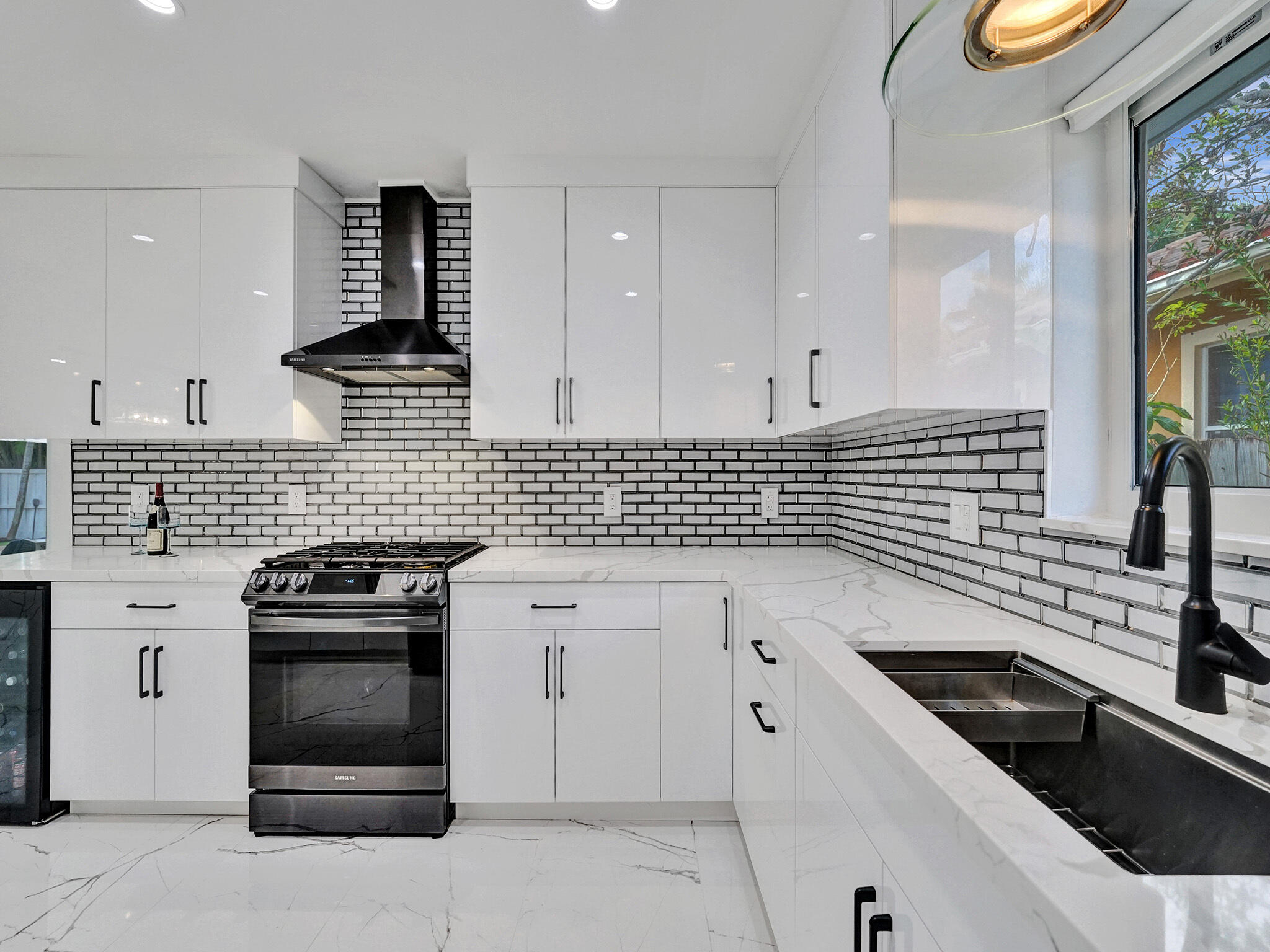 3204 Robbins Road Pompano Beach, FL 33062 - Photo 16 of 37 a kitchen with granite countertop white cabinets and appliances