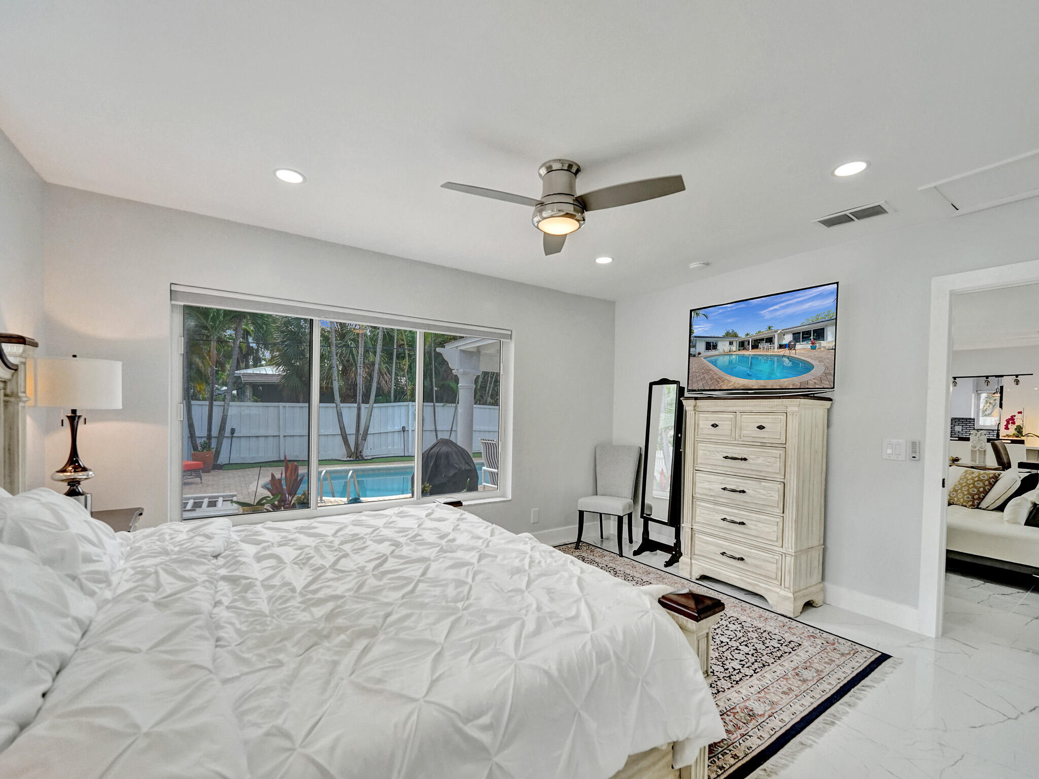 3204 Robbins Road Pompano Beach, FL 33062 - Photo 21 of 37 a large bedroom with a bed and dresser