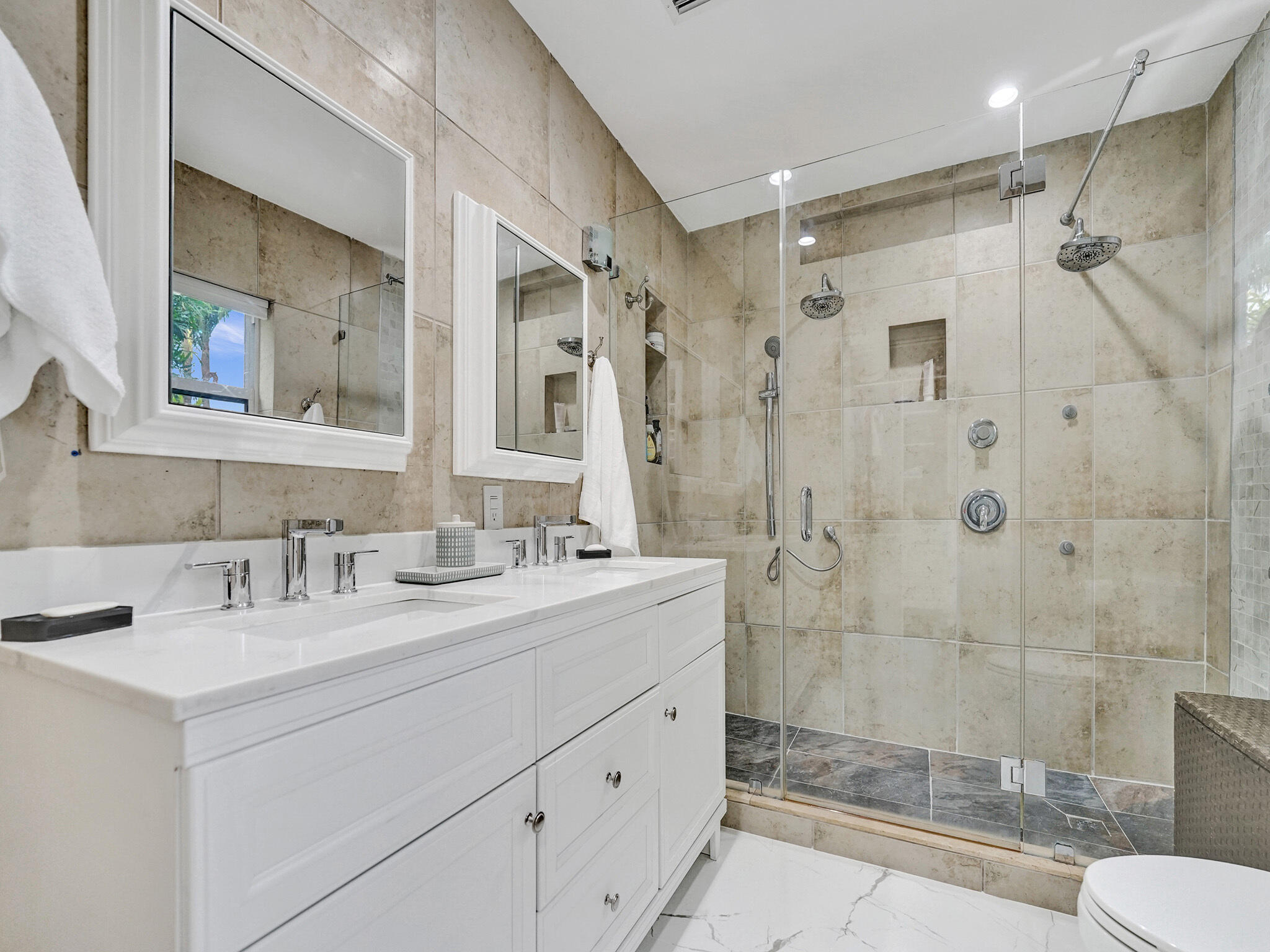 3204 Robbins Road Pompano Beach, FL 33062 - Photo 24 of 37 a bathroom with a double vanity sink mirror double shower