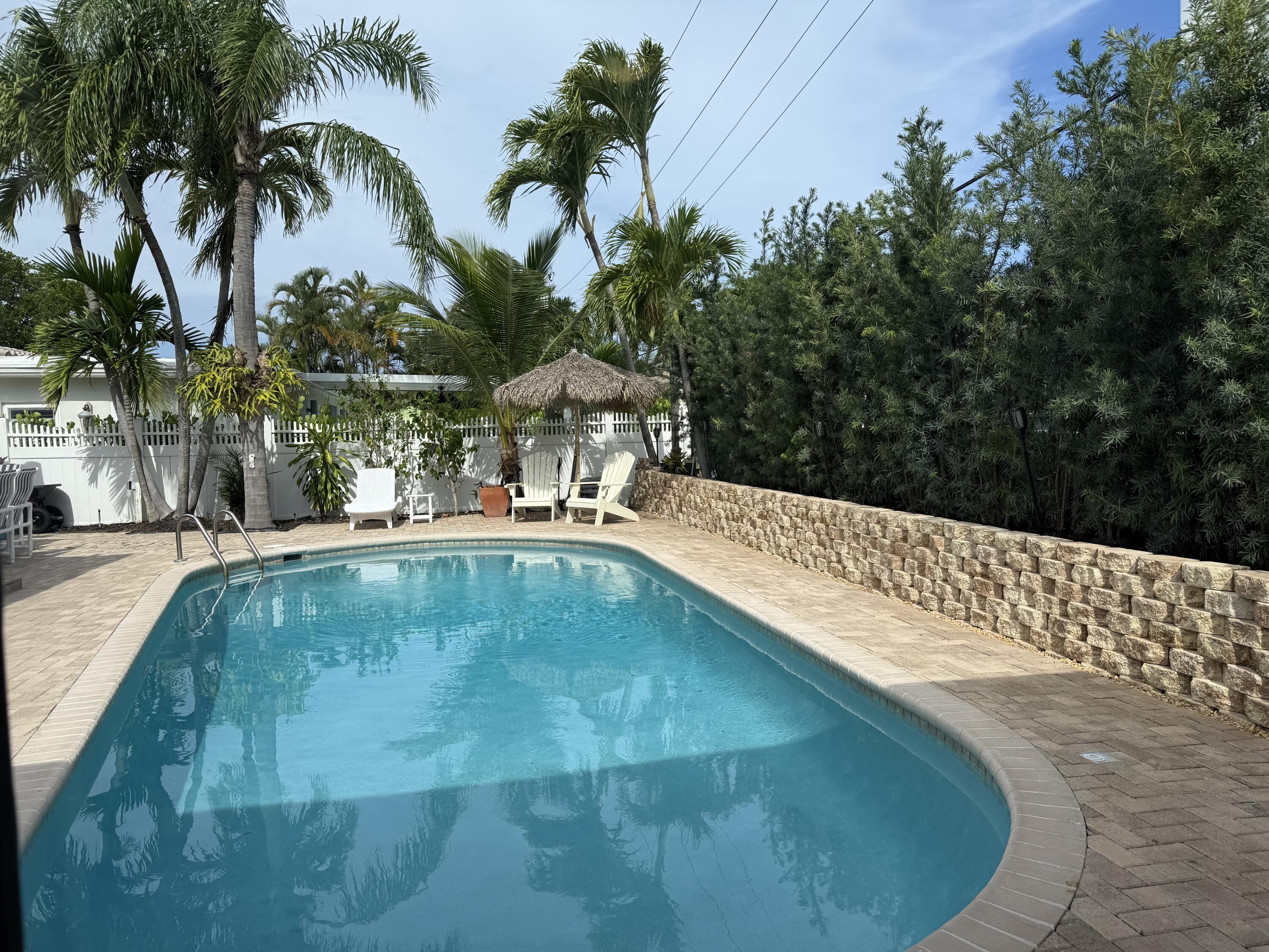 3204 Robbins Road Pompano Beach, FL 33062 - Photo 36 of 37 a swimming pool with outdoor seating and yard