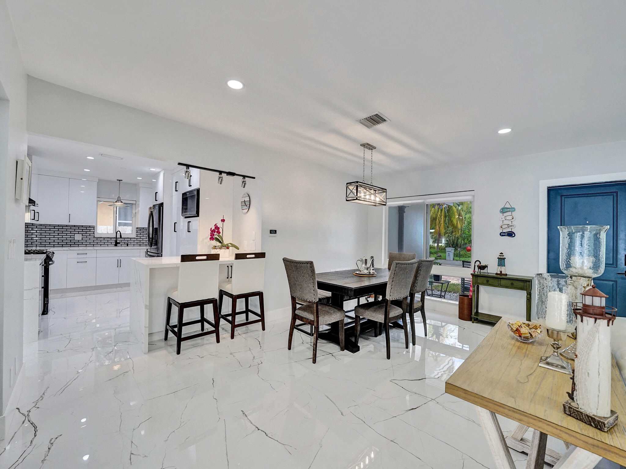 3204 Robbins Road Pompano Beach, FL 33062 - Photo 8 of 37 a view of kitchen with kitchen island dining table and chairs