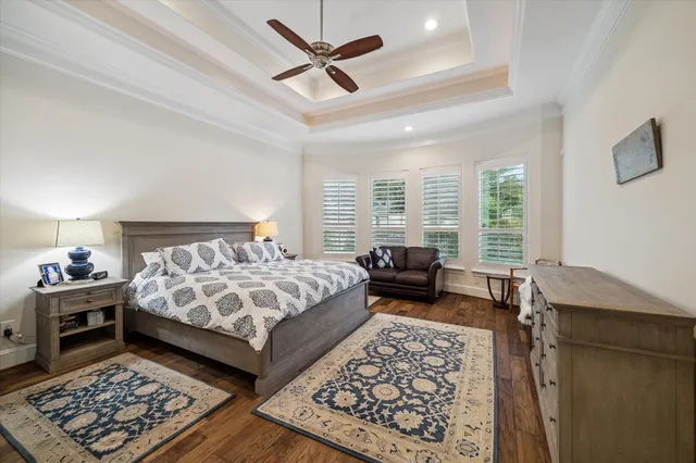 a bedroom with a bed a couch and a window