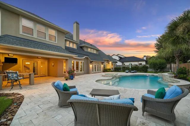 a view of a patio with swimming pool table and chairs