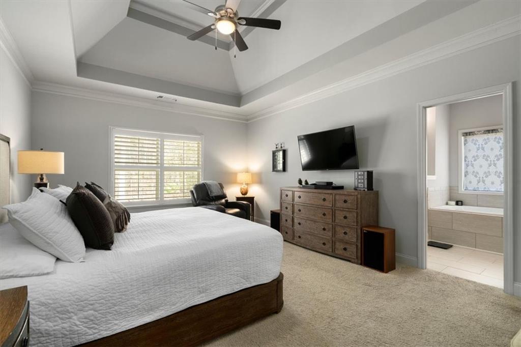 3065 Brooks Trail Monroe, GA 30656 - Photo 18 of 80 a bedroom with a large bed and a flat tv screen on dresser