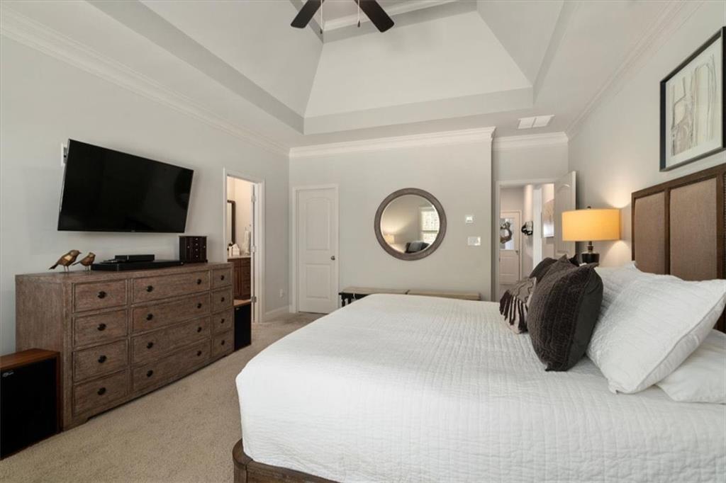 3065 Brooks Trail Monroe, GA 30656 - Photo 19 of 80 a bedroom with a bed and a flat tv screen on dresser