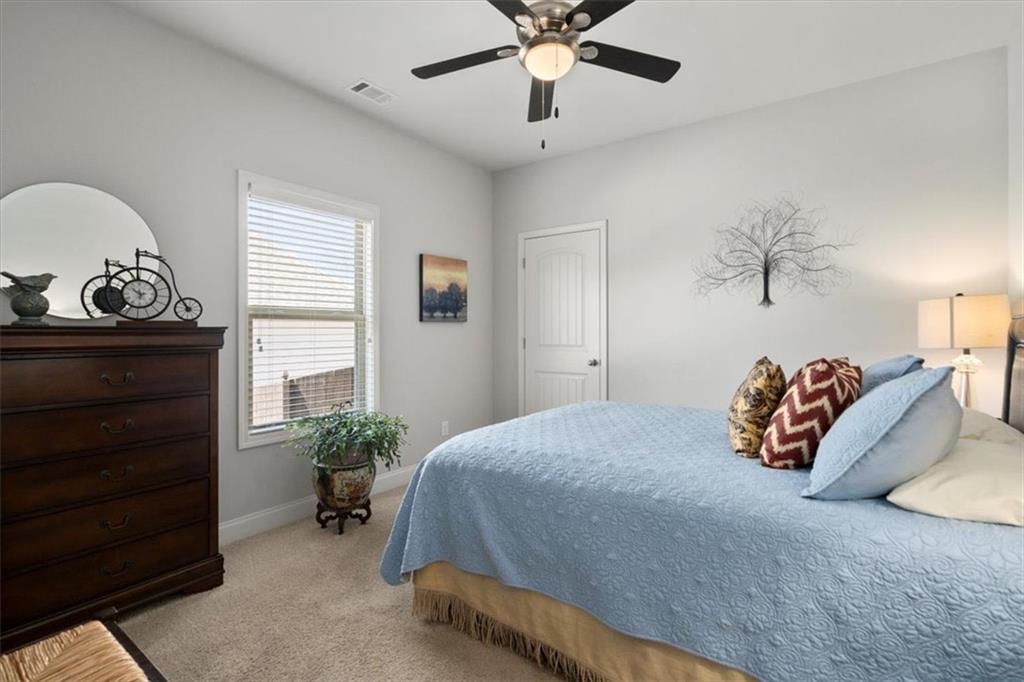 3065 Brooks Trail Monroe, GA 30656 - Photo 25 of 80 a bedroom with a bed and a chandelier