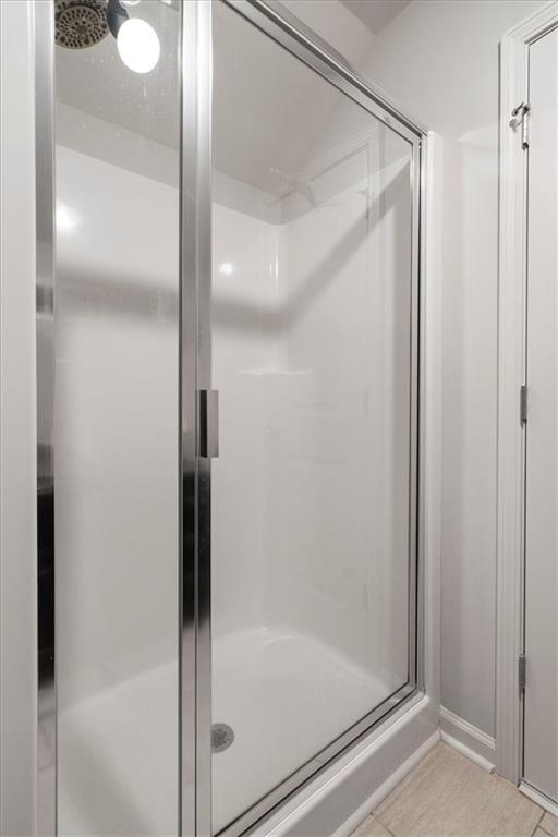 3065 Brooks Trail Monroe, GA 30656 - Photo 32 of 80 a bathroom with a glass shower door and a mirror