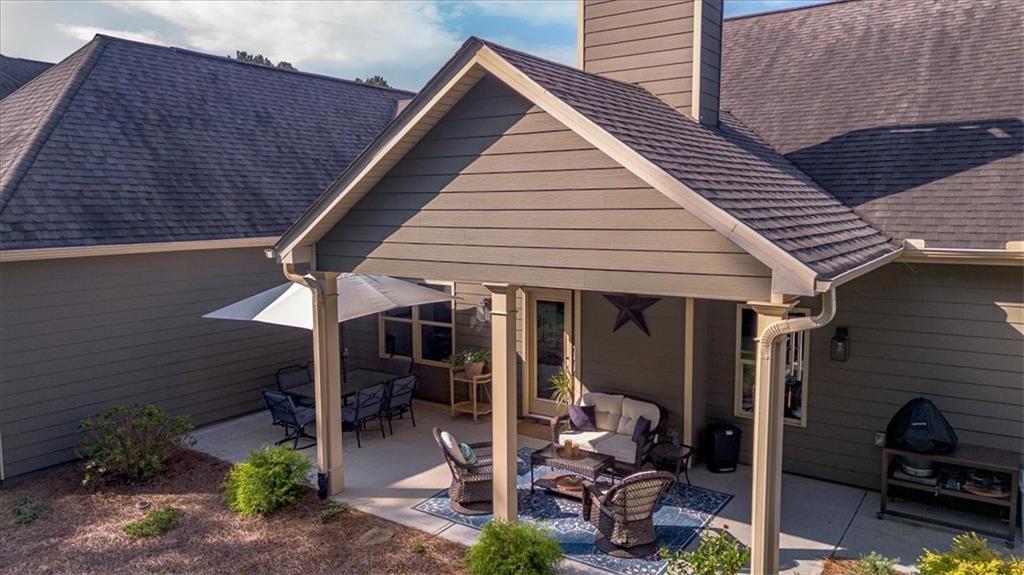 3065 Brooks Trail Monroe, GA 30656 - Photo 66 of 80 a view of a patio with table and chairs under an umbrella