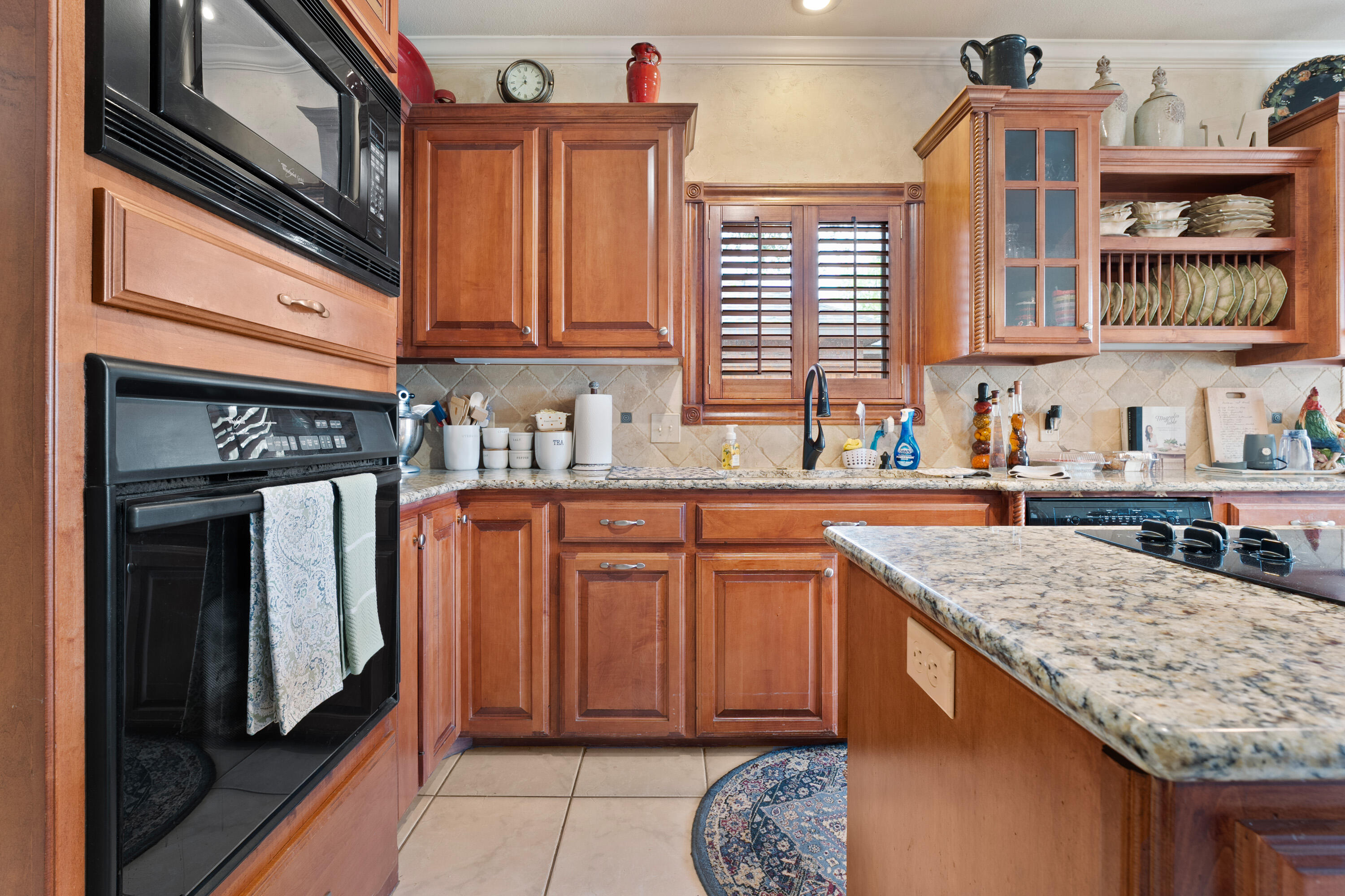 4813 101st Street Lubbock, TX 79424 - Photo 17 of 31 a kitchen with stainless steel appliances granite countertop a sink stove and cabinets