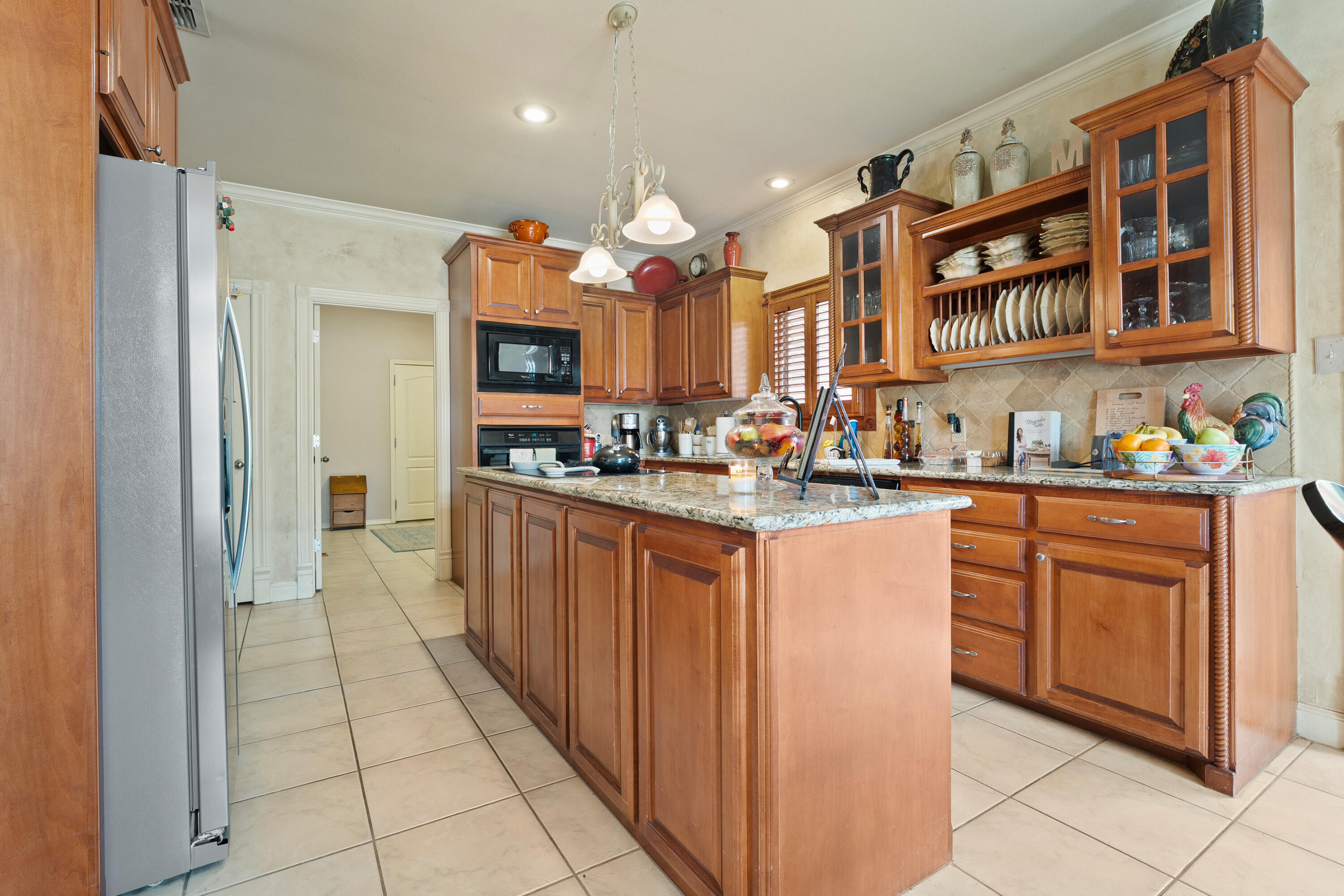 4813 101st Street Lubbock, TX 79424 - Photo 18 of 31 a kitchen with stainless steel appliances granite countertop a stove and cabinets