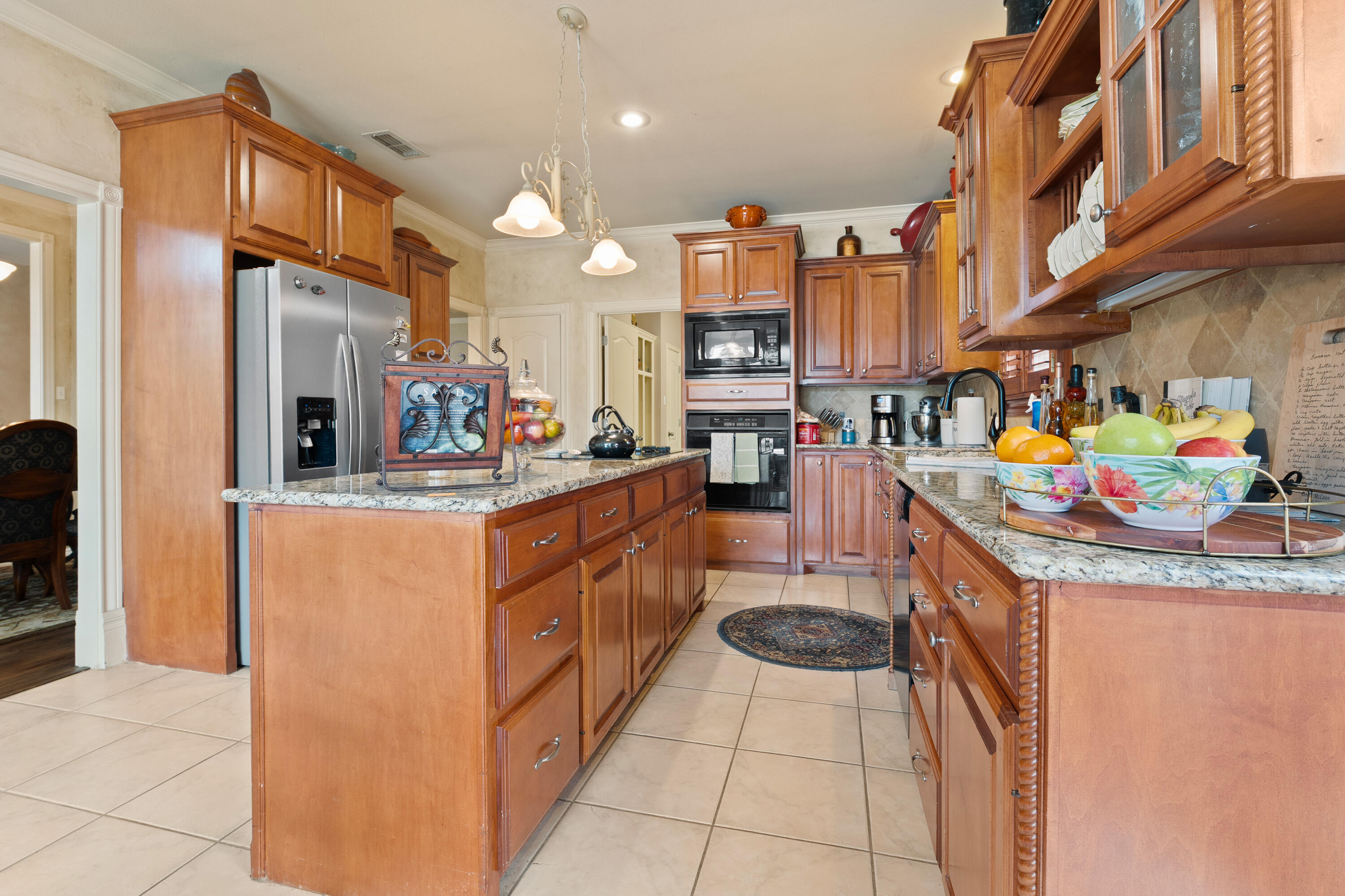 4813 101st Street Lubbock, TX 79424 - Photo 19 of 31 a kitchen with stainless steel appliances granite countertop a sink and a refrigerator