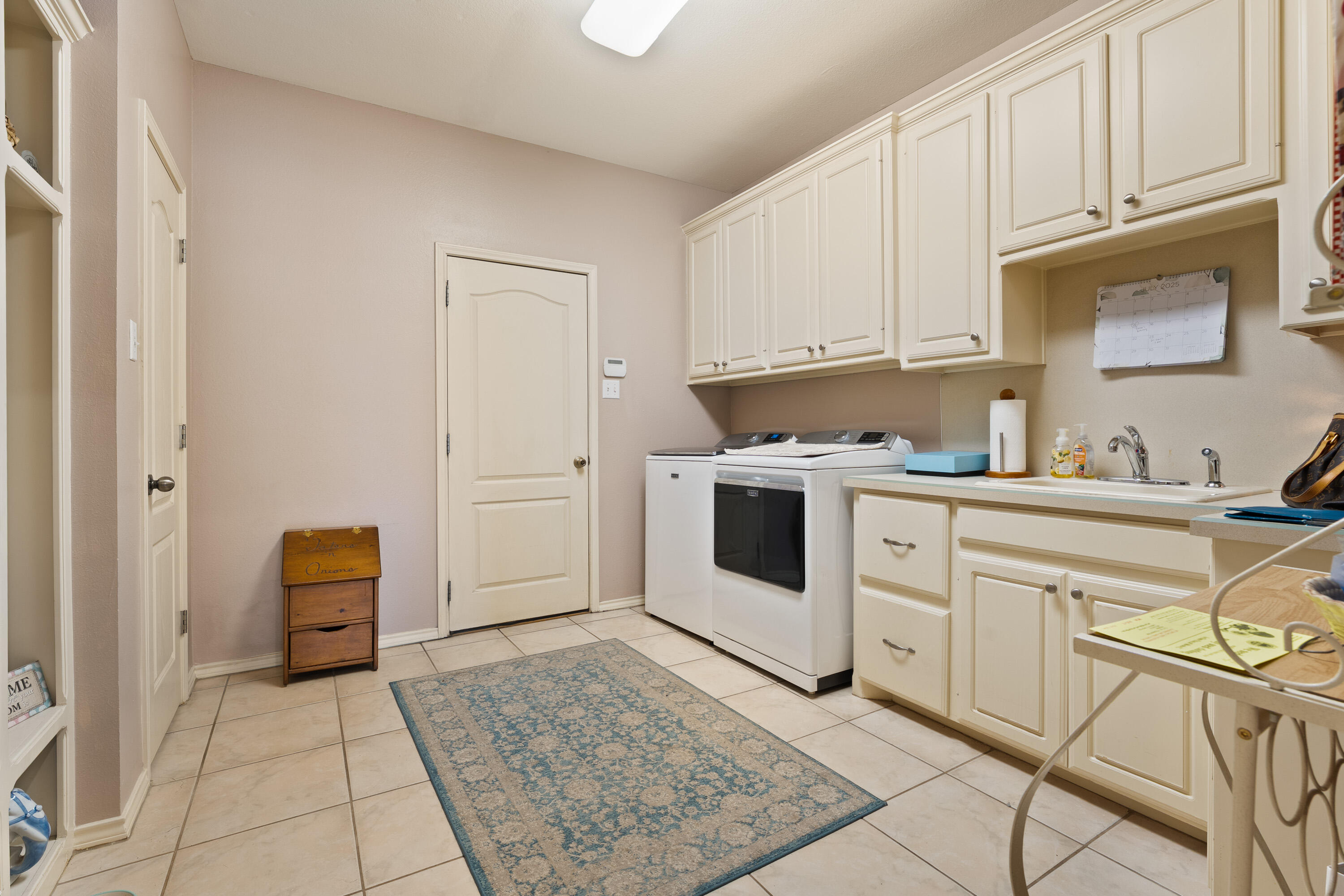 4813 101st Street Lubbock, TX 79424 - Photo 21 of 31 a kitchen with white cabinets and white appliances