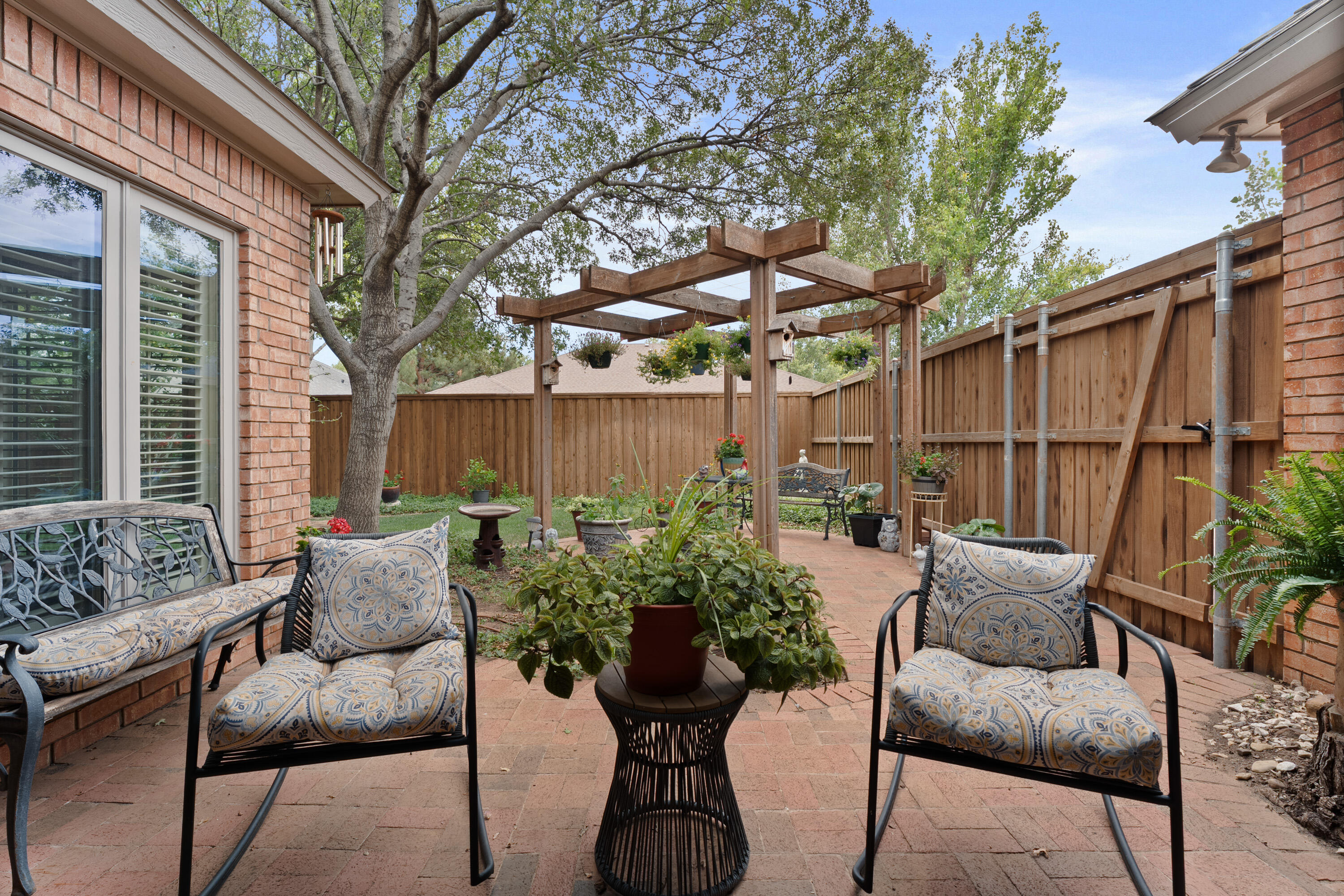 4813 101st Street Lubbock, TX 79424 - Photo 27 of 31 a view of a chairs and table in the back yard of the house