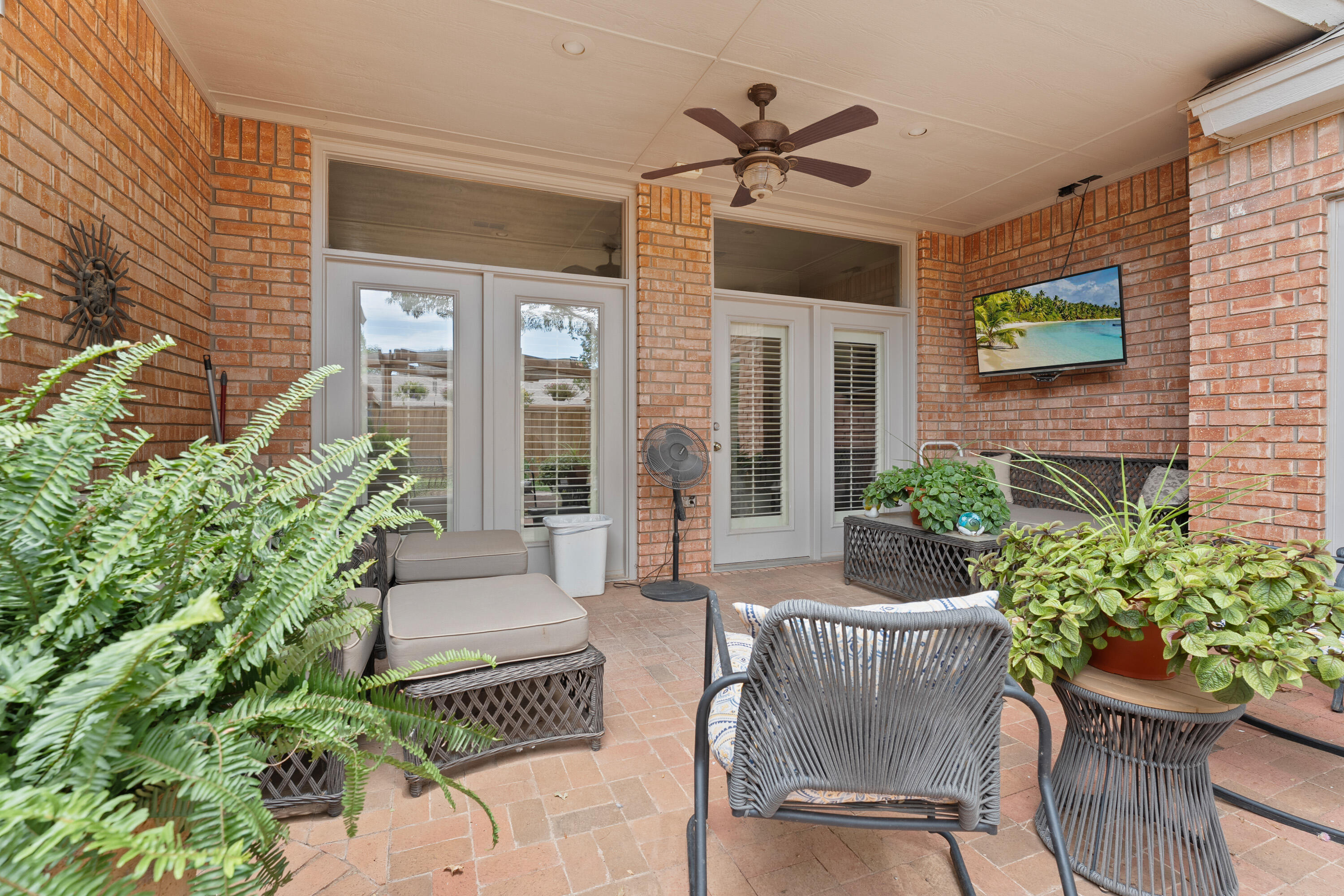 4813 101st Street Lubbock, TX 79424 - Photo 28 of 31 a view of a patio with couches table and chairs and potted plants