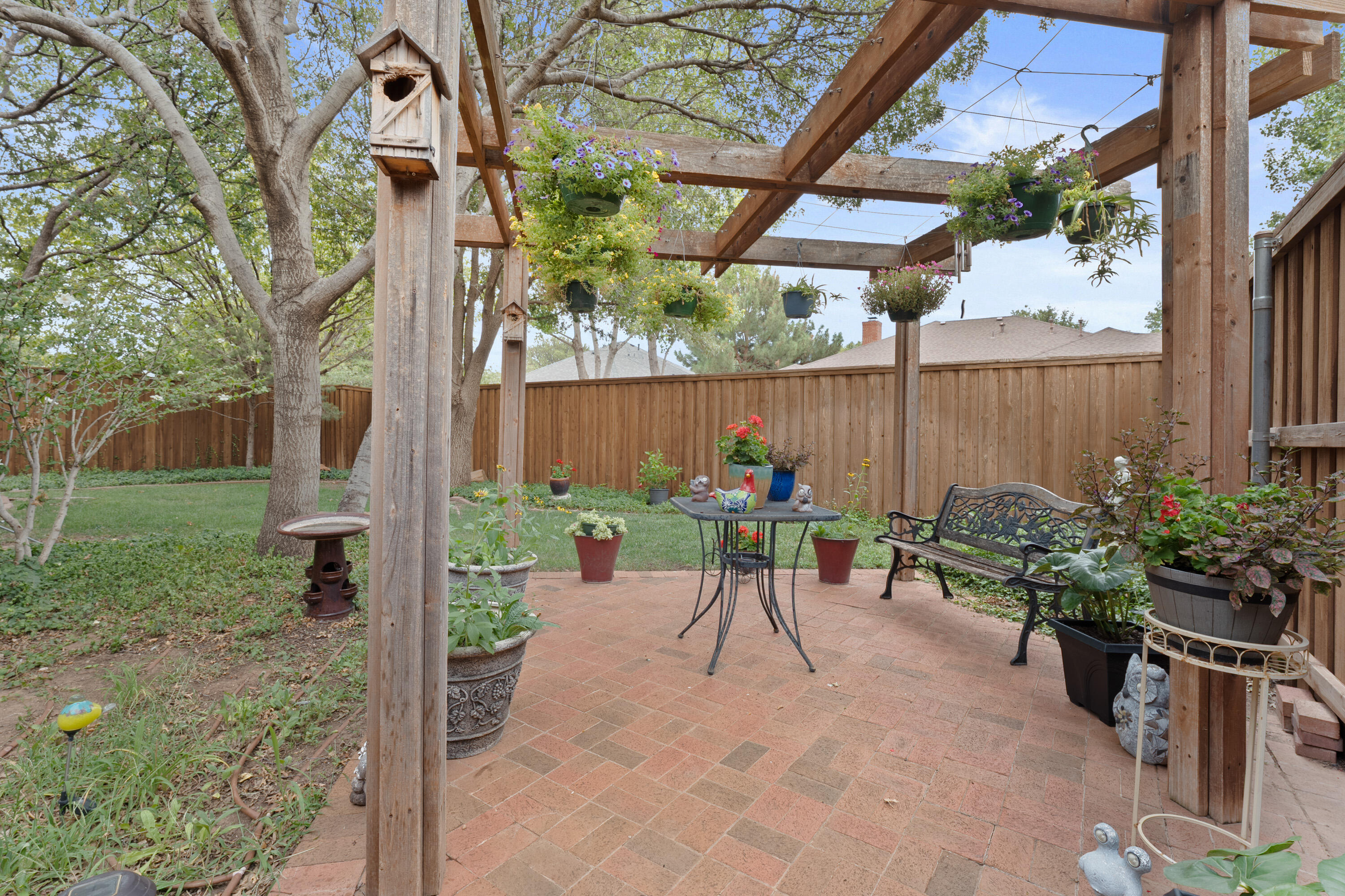 4813 101st Street Lubbock, TX 79424 - Photo 29 of 31 a view of a chairs and table in backyard of the house