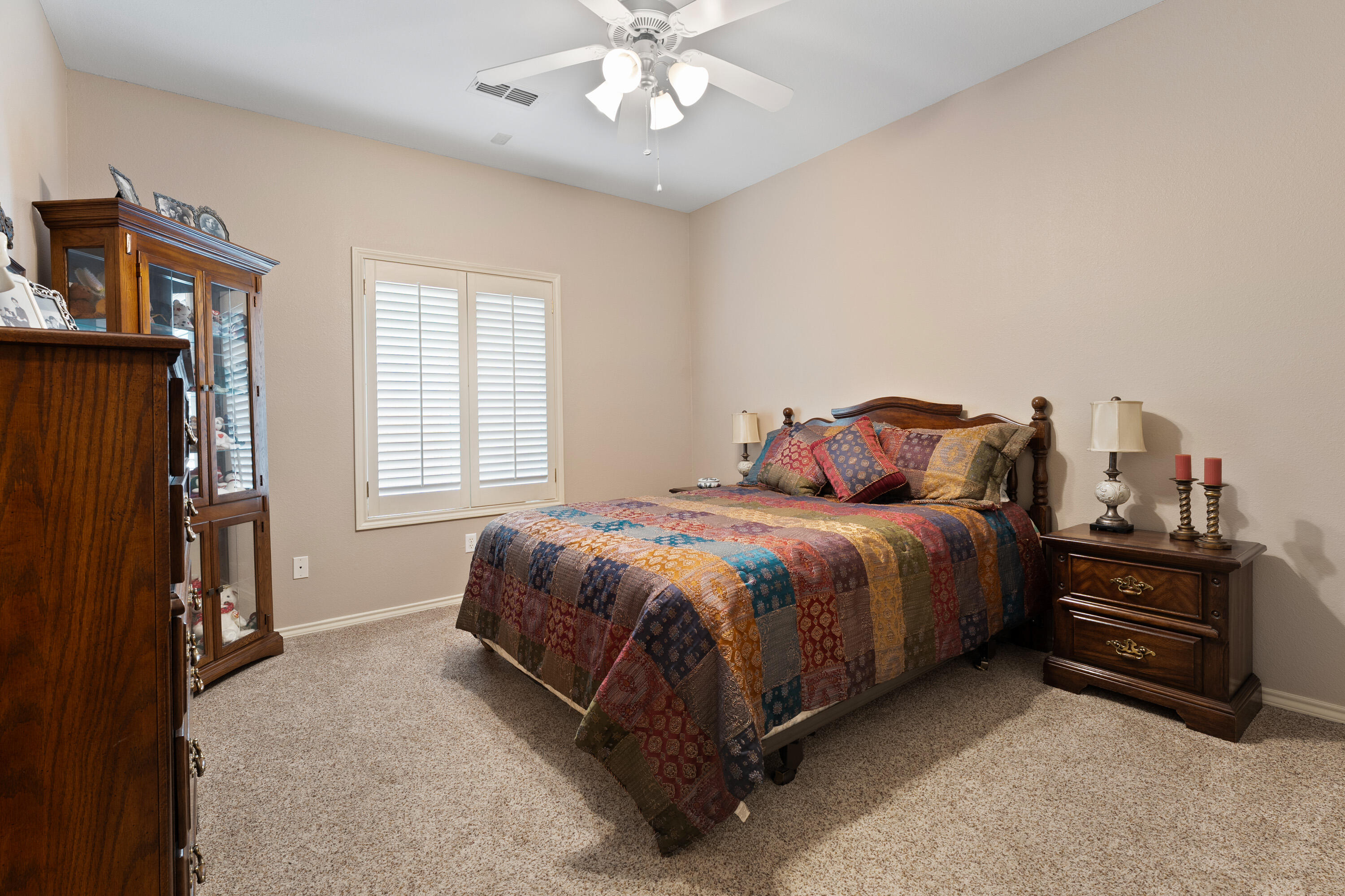 4813 101st Street Lubbock, TX 79424 - Photo 8 of 31 a bedroom with a bed and a chandelier