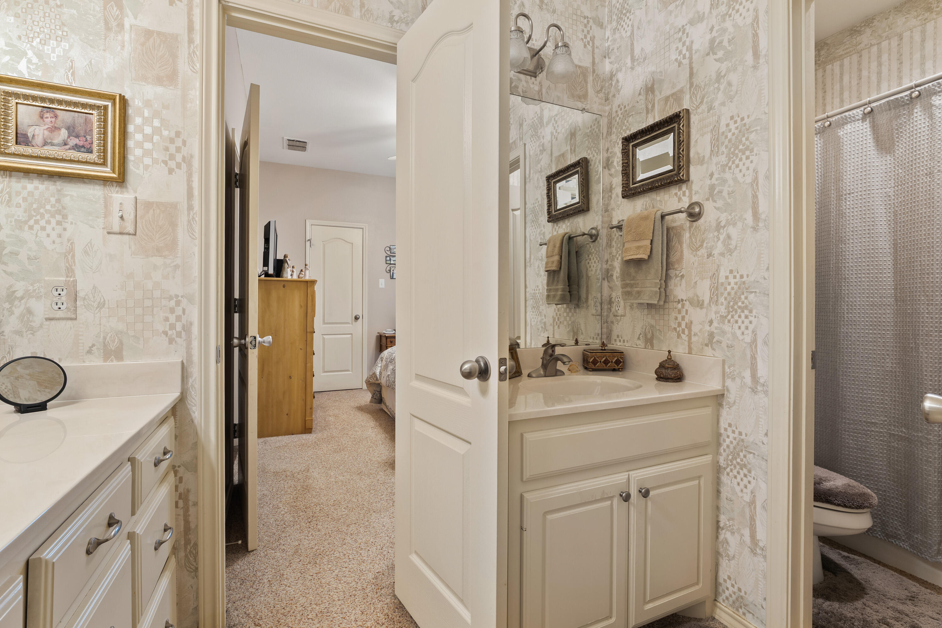 4813 101st Street Lubbock, TX 79424 - Photo 9 of 31 a bathroom with a sink a toilet and shower