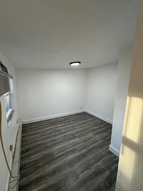 920 Haverhill Road, Unit 1B Haverhill, FL 33415 - Photo 3 of 6 a view of an empty room and wooden floor