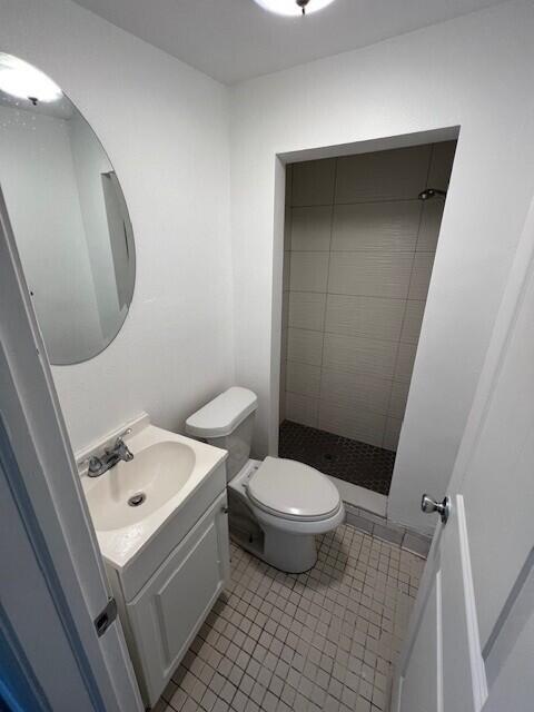 920 Haverhill Road, Unit 1B Haverhill, FL 33415 - Photo 5 of 6 a white toilet sitting next to a bathroom sink