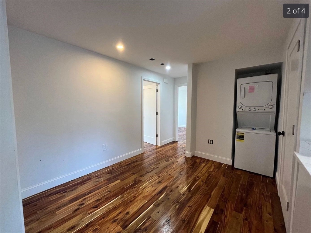 155 Orange Street, Unit B Chelsea, MA 02150 - Photo 2 of 4 a view of an empty room with wooden floor