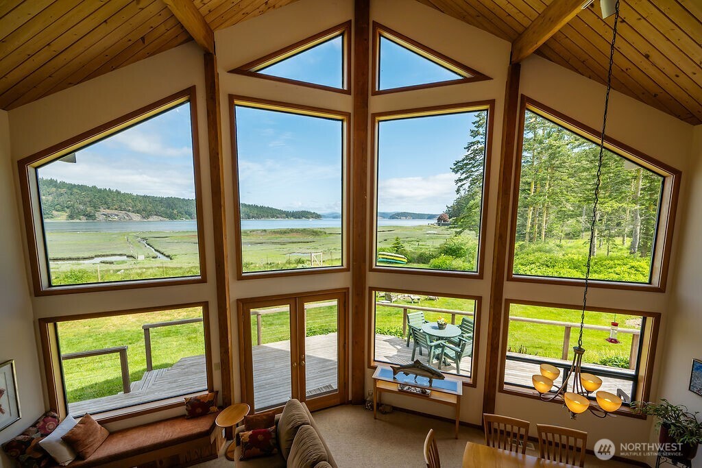 3757 Mud Bay Road Lopez Island, WA 98261 - Photo 8 of 40 a view of an empty room with large windows and a table