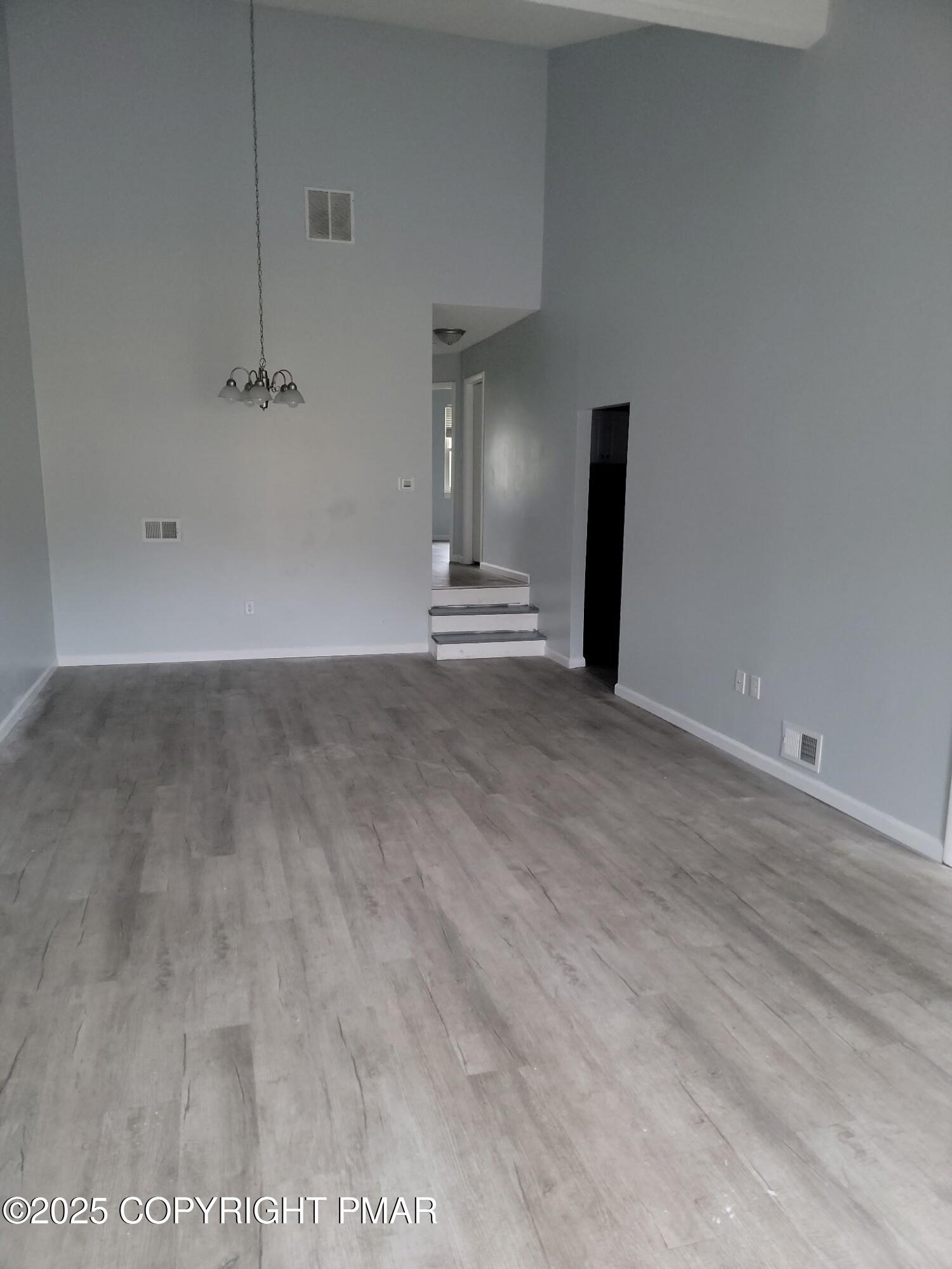 151 Snowshoe Court, Unit 204 Mount Pocono, PA 18344 - Photo 1 of 8 a view of empty room with wooden floor