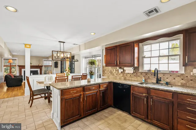a large kitchen with a sink and cabinets