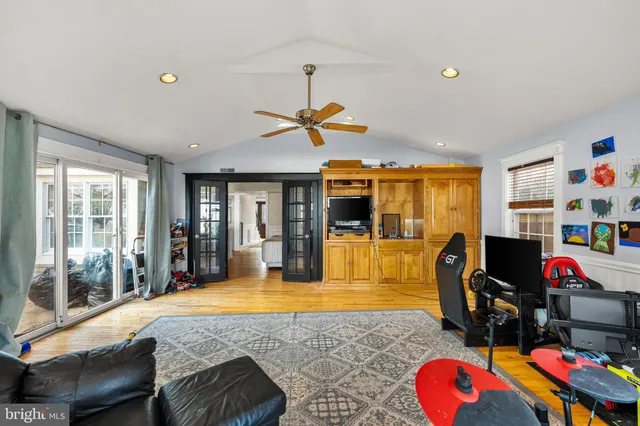 a living room with furniture pool table and flat screen tv