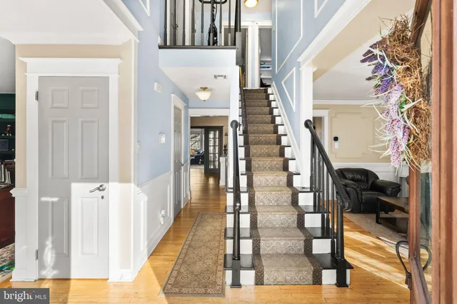 a view of entryway and hall with wooden floor