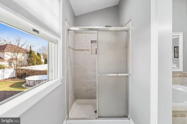 a bathroom with a glass shower door
