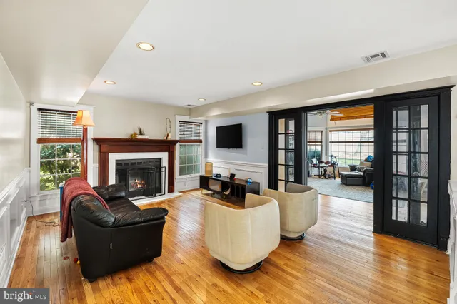 a living room with fireplace furniture and a flat screen tv