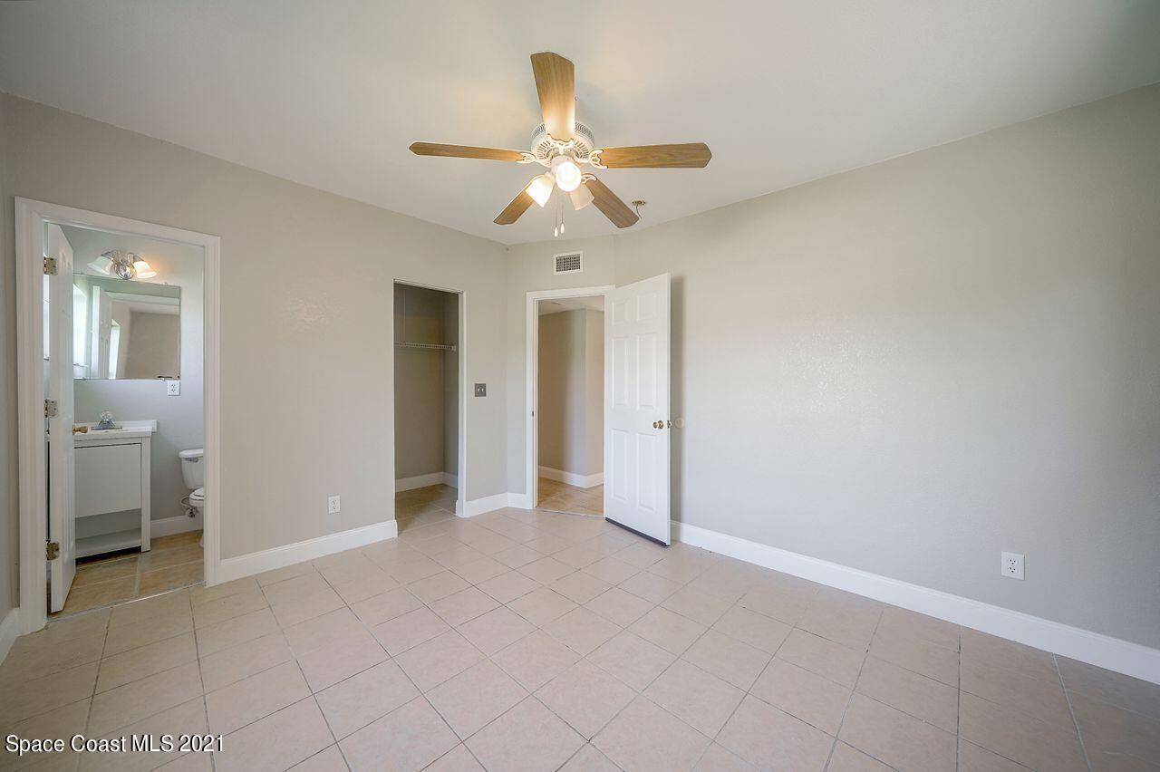 1197 Croton Road Melbourne, FL 32935 - Photo 8 of 26 an empty room with closet and a chandelier fan