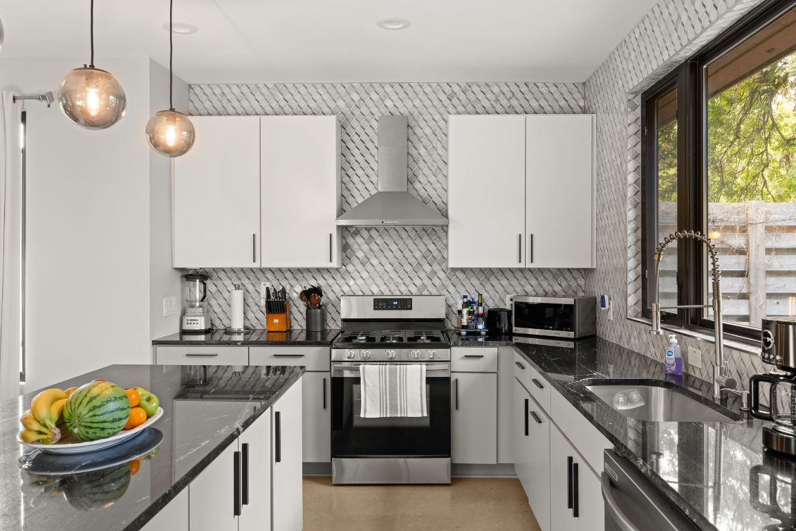 3610 Thompson Street, Unit 1 Austin, TX 78702 - Photo 1 of 39 a kitchen with granite countertop a stove a sink and a granite counter tops
