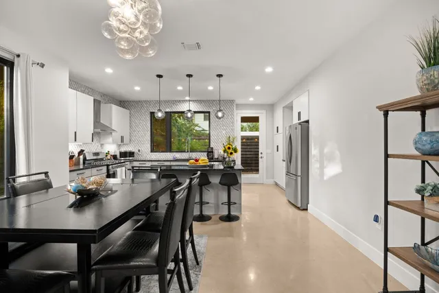 a kitchen with stainless steel appliances granite countertop a sink a stove and a wooden cabinets