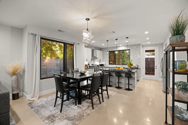 a kitchen with granite countertop a sink a stove and cabinets