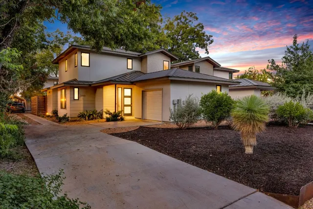 a view of a house with a yard and plants