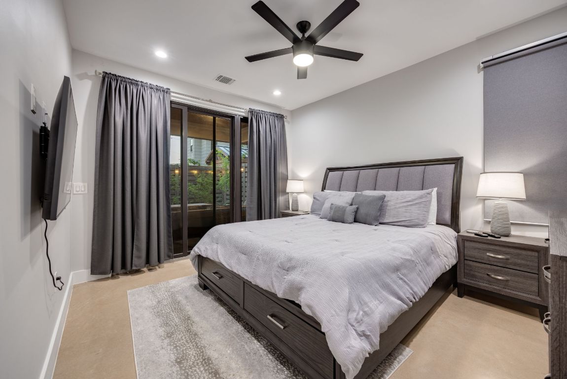 3610 Thompson Street, Unit 1 Austin, TX 78702 - Photo 21 of 39 a bedroom with a large bed and a flat tv screen