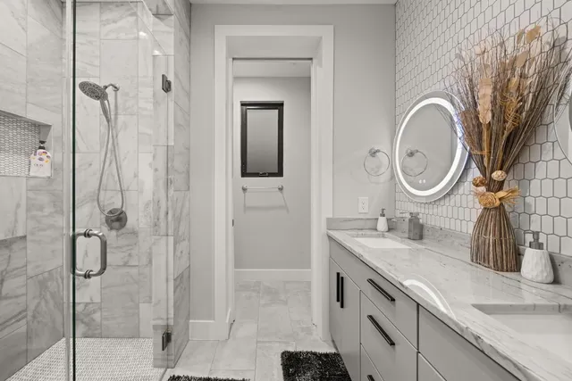 a bathroom with a granite countertop sink a toilet and shower