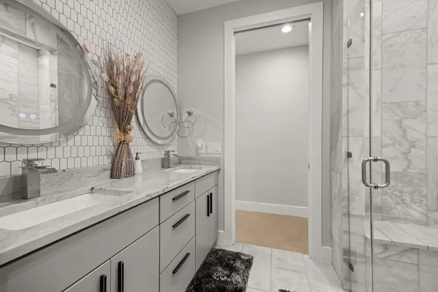 a bathroom with a granite countertop toilet and a sink