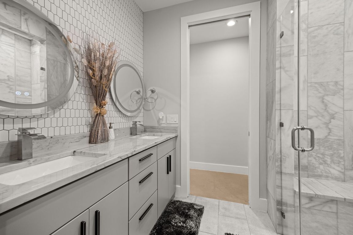 3610 Thompson Street, Unit 1 Austin, TX 78702 - Photo 26 of 39 a bathroom with a double vanity sink mirror and shower