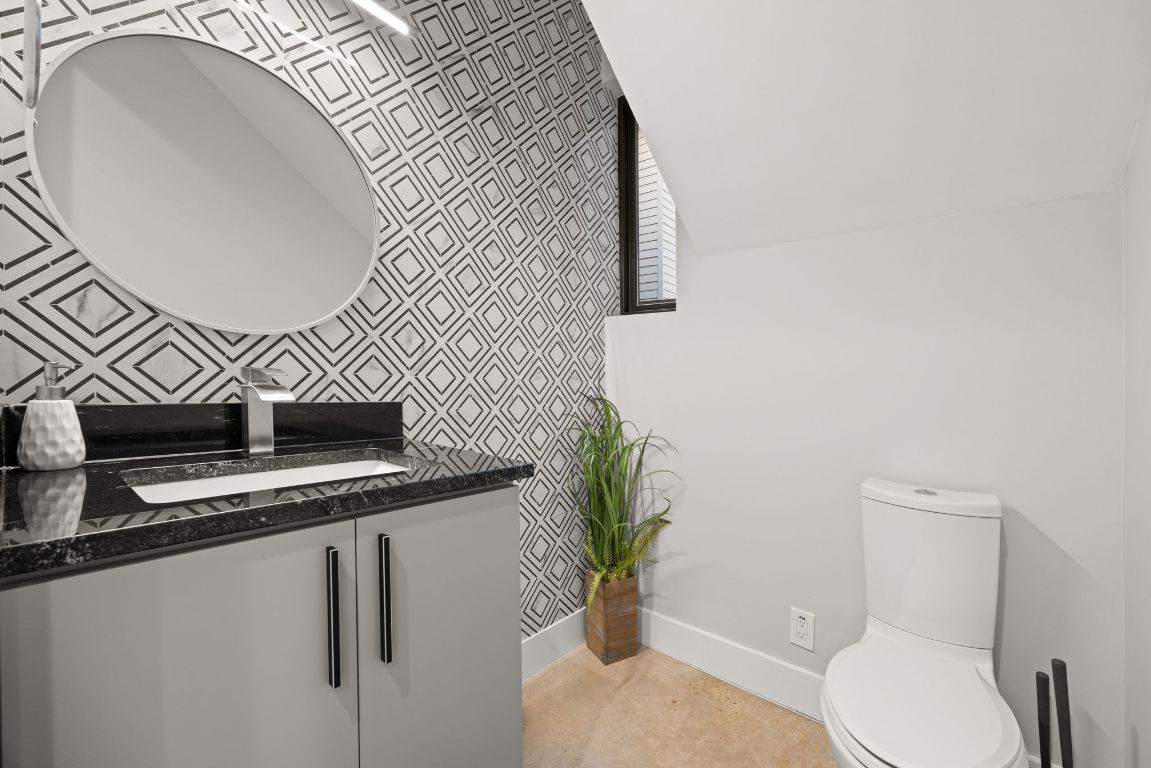3610 Thompson Street, Unit 1 Austin, TX 78702 - Photo 28 of 39 a bathroom with a granite countertop toilet and a sink