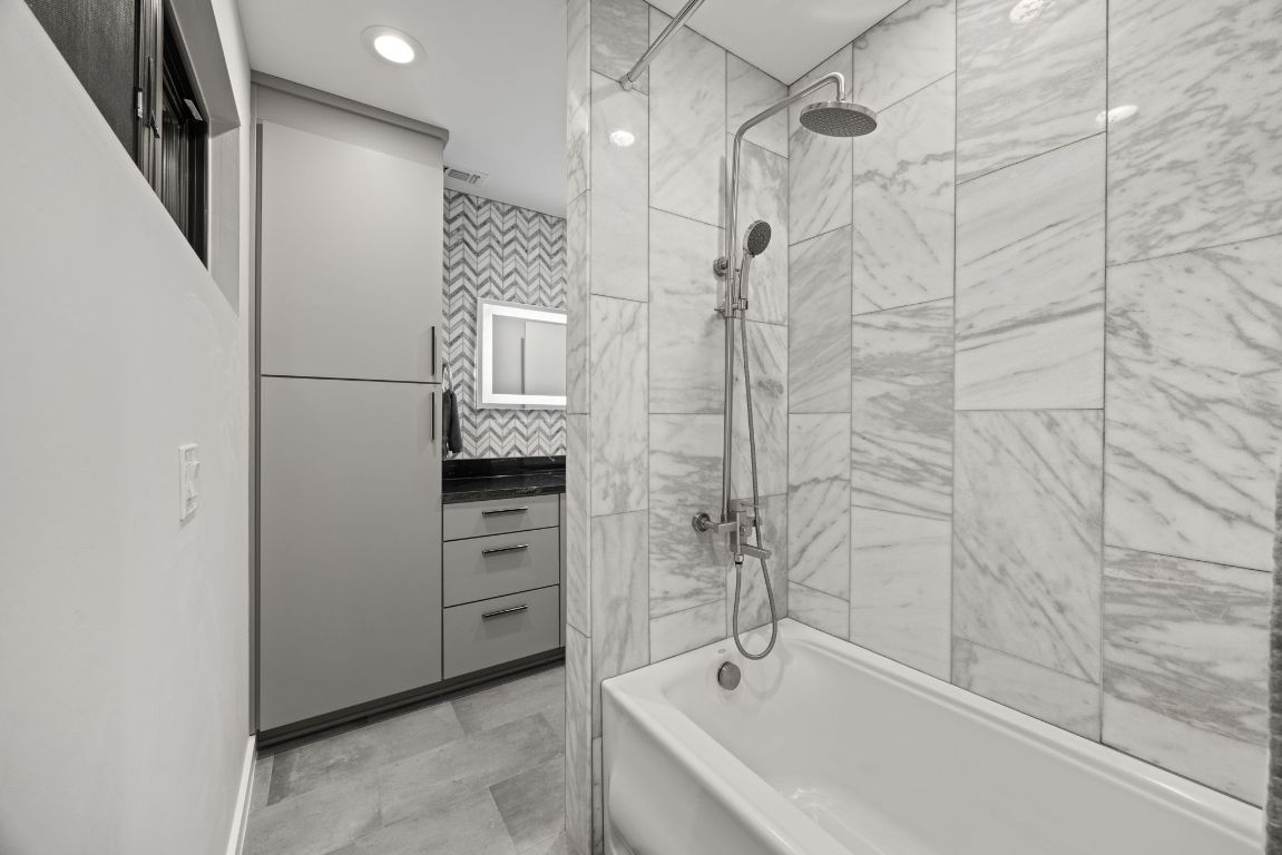 3610 Thompson Street, Unit 1 Austin, TX 78702 - Photo 34 of 39 a bathroom with a bathtub and a shower