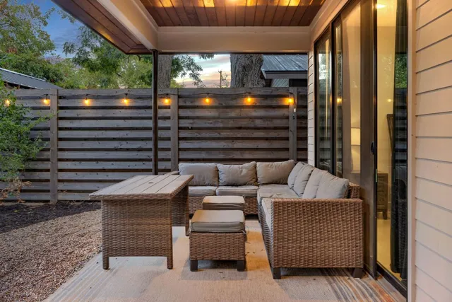 a backyard of a house with outdoor seating