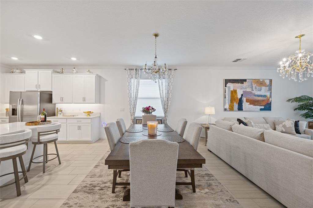 5513 Little Path Drive Wimauma, FL 33598 - Photo 13 of 40 a view of a dining room with furniture and chandelier